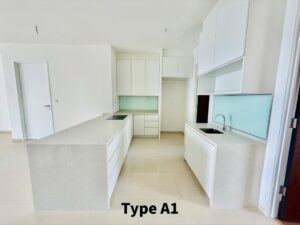 Modern white kitchen with a large central island, cooktop, and a secondary island with a sink in a bright space.