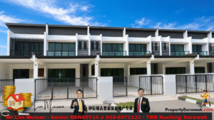 Front view of a modern townhouse complex with white and gray facade and gated driveways; two suited real estate agents stand in front.