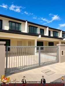 Gated row of beige townhouses with large black-framed windows under a blue sky, concrete driveway in front.