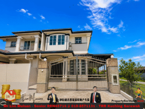 Front view of a large two-story house with a decorative iron gate and a paved entry, blue sky overhead, part of a real estate ad banner at the bottom.