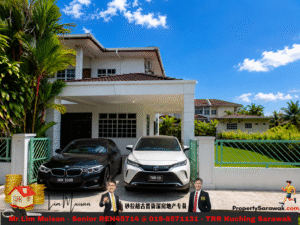 Two-story white house with a tiled roof and covered driveway; a black BMW and a white Toyota parked in front, surrounded by tropical plants.