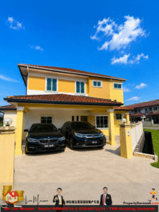 Two-story yellow house with a red-tiled roof and two black cars parked in a covered driveway under a clear blue sky.