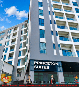 Modern high-rise building with glass balconies and a bold Princeton Suites sign at the entrance under a blue sky; two men in suits near the doorway.