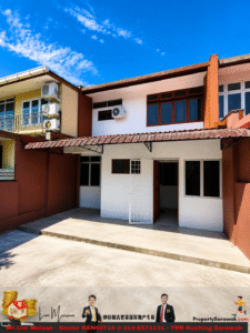 Two-story house with white walls and red-brown trim, tiled roof, and several outdoor air conditioning units against a bright blue sky.