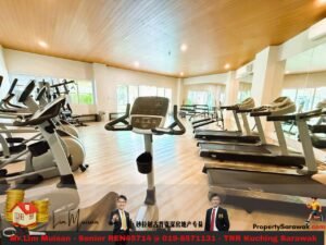 Bright gym with cardio machines including treadmills and stationary bikes along a wooden-ceilinged room with large windows.