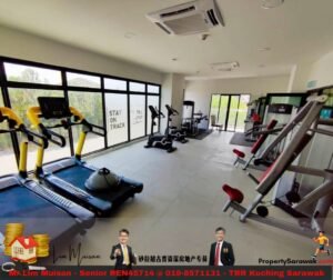 Modern gym interior with cardio machines (treadmills, bikes) along a bright window wall and weight machines nearby.