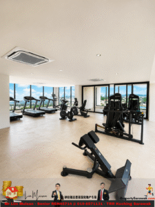 Well-lit gym with treadmills and stationary bikes facing large windows overlooking the city skyline.