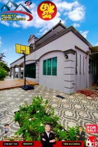 Exterior view of a modern gray house with patterned tiled courtyard, a 'For Sale' sign, and promotional graphics in the sky area for a property listing site.