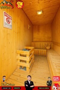 Wooden sauna interior with benches and a bucket; wall sign reads 'Attention: Do Not Pour Water In Sauna' and sale logos overlay the image.