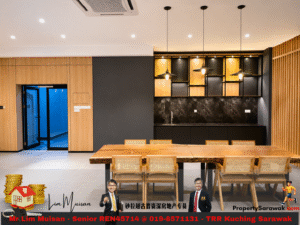 Modern open dining area with a large wooden table, woven chairs, black marble backsplash, and wooden wall shelves under warm pendant lighting.