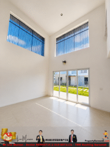 Bright empty living area with tall white walls, tiled floor, and large blue-vented windows near the ceiling; glass sliding door opens to a green lawn outside.