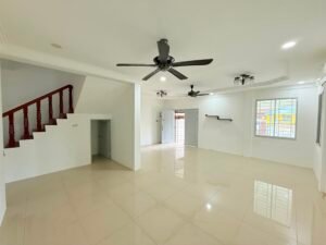 Bright, empty living room with white walls, glossy tile floor, and a wooden-railed staircase on the left; ceiling fans and lights overhead.