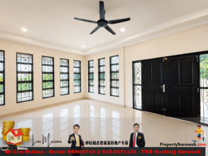 Bright empty living room with white walls, a row of tall black-framed windows, a large black front door, and a ceiling fan overhead.