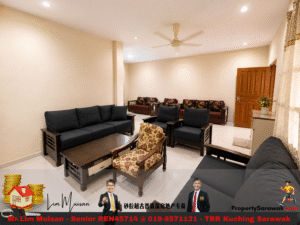 A spacious living room with dark blue sofas, a central wooden coffee table, and a floral armchair on a glossy tiled floor.