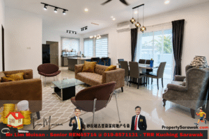 Open-plan living and dining room with brown sofas, a glass coffee table, and a kitchen island, sunlit by large windows with sheer curtains. A separate gray armchair and dining table with six chairs are visible, plus decorative lighting fixtures and an outdoor view. Banner ad with two men in suits spans the bottom.