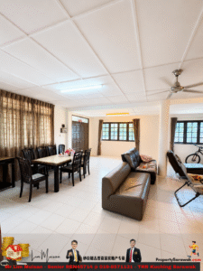 Open-plan living and dining area with a long dining table and dark chairs, a gray leather sofa, and large windows with brown curtains.