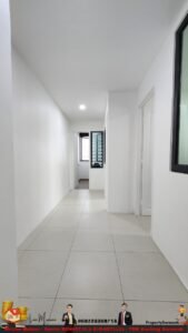 Bright white hallway in a modern apartment with large tiled floor, doors on the right, and a window with blinds at the far end.