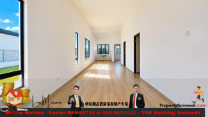 Bright, empty living space with light wood floors and tall windows along one wall, flooding the room with natural light. A doorway leads to other rooms in the distance. The bottom advertisement bar is visible.
