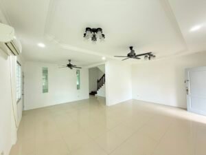 Bright, spacious living room with white walls, glossy tile floor, two ceiling fans, and a staircase at the back near an open doorway.