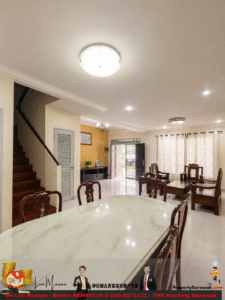 Open-plan living and dining area with a marble dining table, wooden chairs, staircase on the left, and glass doors to the outside.
