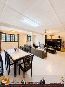 Open-plan living and dining room with a glass-top dining table, dark wooden chairs, gray sofas, TV stand, and large windows with brown curtains.