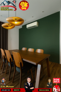 Modern dining room with a large wooden table and six wooden chairs, dark green wall, beige ceiling, woven gold pendant lights, and a wall-mounted air conditioner; decorative logos are visible in the corners as overlays.