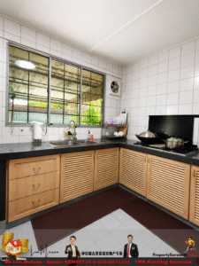 U-shaped kitchen with white tiled walls, light wood cabinets, black countertop, sink under a large window, and a stove with two pots on the right.