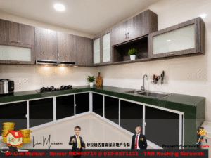 Modern L-shaped kitchen with dark wood cabinets, green countertops, gas stove, and double sink; small potted plant decorates the counter area.