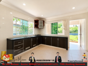Bright L-shaped kitchen with dark wood cabinets, stainless sink, and gas stove, illuminated by large windows overlooking a green yard.