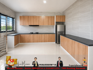 Bright, modern L-shaped kitchen with wood cabinets, gray tiled walls, black countertops, and a stainless steel refrigerator near a large window with bars.