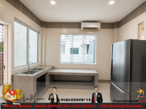 Modern kitchen with double sink, gray countertops, beige tile walls, and a stainless steel fridge.