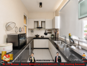 Modern L-shaped kitchen with white cabinets, black countertops, and a stainless steel oven/range hood setup centered against the back wall.