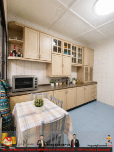 Light wood kitchen with glass-front cabinets, a toaster oven on the counter, and a plaid-dining table in the foreground.
