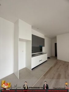 Modern kitchen with white base cabinets, gray wall cabinets, built-in oven, sink, and a doorway to a hallway; tile to wood flooring transition.