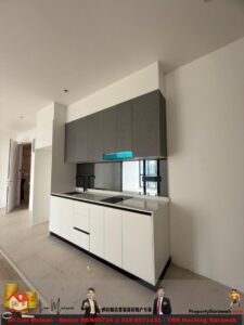 Modern white kitchen with grey upper cabinets, black faucet, induction hob, and a window view; construction site look in the background.