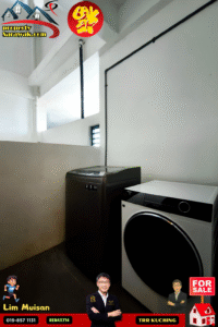 Interior laundry area with a dark top-loading dryer beside a front-loading washer against white walls; Property Sarawak logo in the corner and a red 'FOR SALE' badge bottom right.