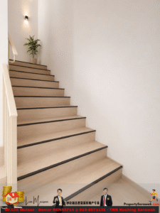 Wooden indoor staircase with black edge trim, white walls, and a potted plant at the landing; soft wall light above illuminating the space.