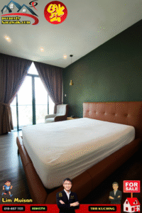 Bedroom with a large brown leather bed, dark green wall, gold pendant light, and a chair by a glass door with brown curtains.