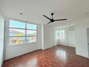 Bright empty living room with large windows, white walls, and a black ceiling fan over parquet flooring.