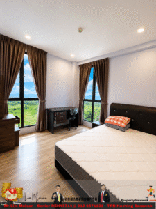 A bright bedroom with a tufted black headboard bed, two large windows with brown curtains, and a desk with chair near the window, overlooking a green landscape.