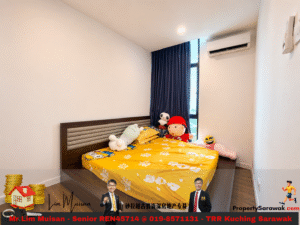 Bedroom with a low wooden bed frame, yellow floral bedsheet, and stuffed animals by the window; blue curtains and an air conditioner on the wall.