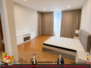 Bedroom with a boxed mattress on a gray upholstered bed frame, a white media console, wood flooring, and tall beige curtains by a large window.