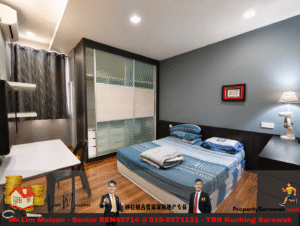 Modern bedroom interior with a blue accent wall, bed with blue bedding, a frosted-glass sliding wardrobe, and a desk with a chair nearby.