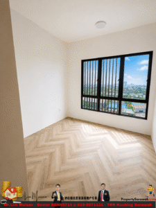 Empty bright room with white walls, light wooden herringbone floor, and a large window overlooking a cityscape.