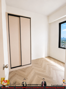 Empty minimalist room with a beige sliding-door closet, light wood herringbone flooring, white walls, and a large window revealing a city skyline outside.