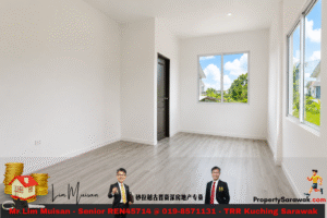 Bright empty room with white walls, light wood floor, a dark door, and large windows showing a sunny green yard outside.