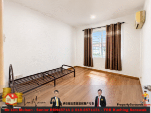 Empty bedroom with a metal bed frame along the left wall, wood flooring, a window with brown curtains, and a wall-mounted air conditioner above the window.