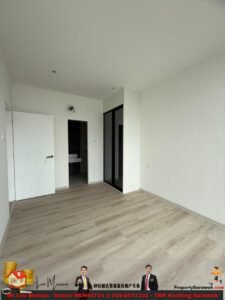 Empty modern bedroom with white walls, light wood flooring, a built-in wardrobe with mirrored sliding doors, and an open doorway to a bathroom.
