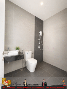 Modern bathroom with a white toilet, floating marble sink, and a wall-mounted shower on a dark gray tile accent wall. A small plant sits on the sink counter; neutral gray tiles cover the walls and floor.
