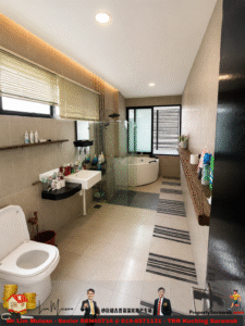 Beige-tiled bathroom with a wall-mounted sink and an open storage shelf full of toiletries, a glass-enclosed shower, and a free-standing tub by a window at the far end.